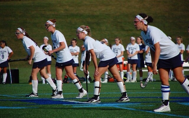 Field Hockey payers wait for the corner to start