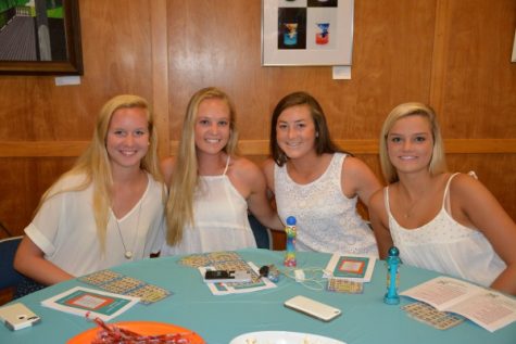 Seniors Catherine Kiern, Emily Cooper, Grace Haus, and Cameron Diggins gather at their table for the festivities!