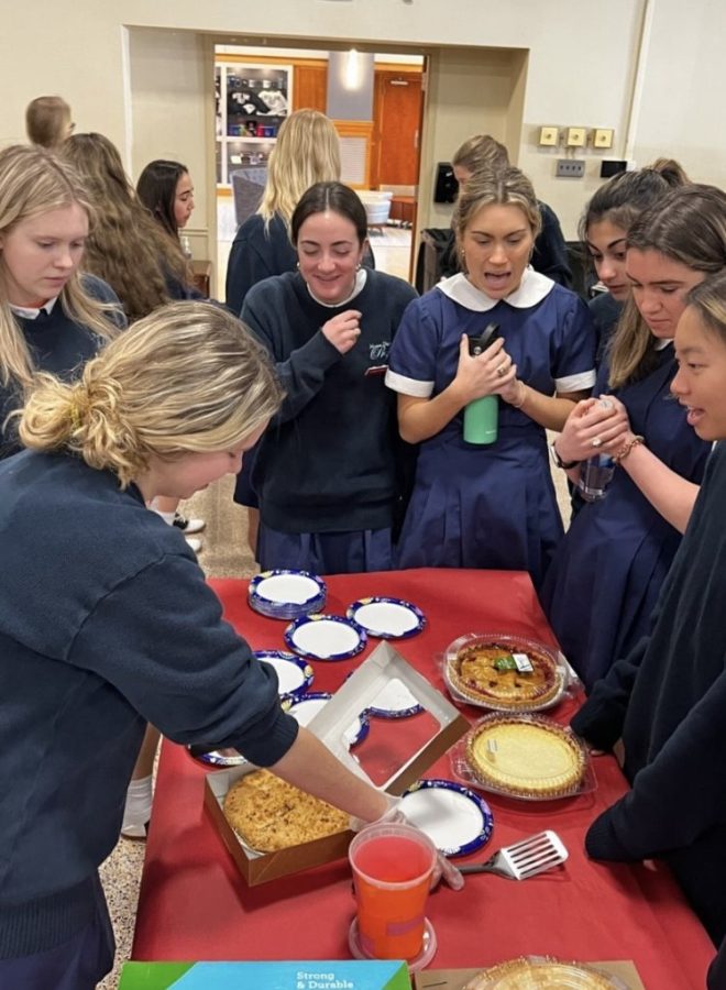 Juniors gather around pies. (Photo via Instagram @notredameprep)