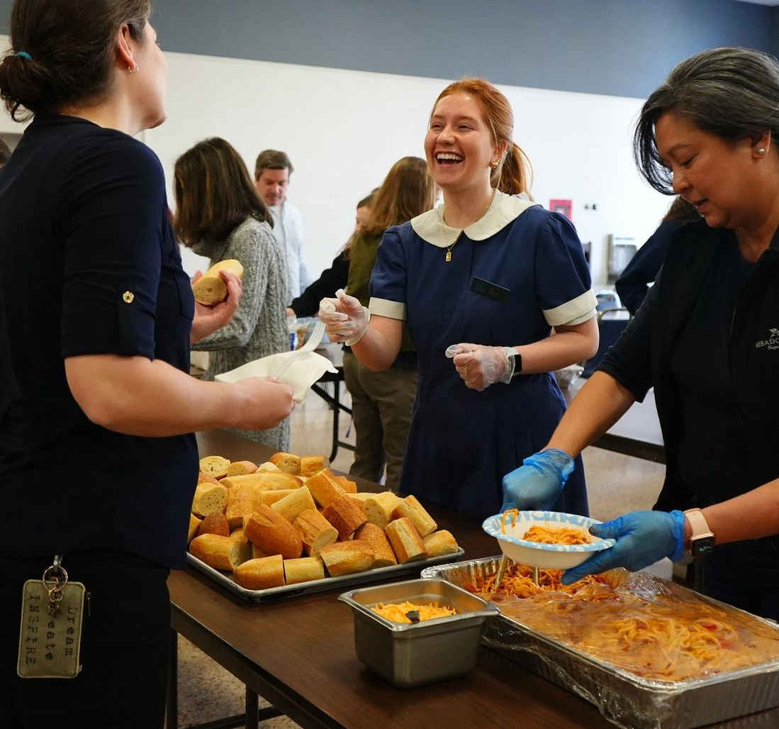 CCAP President Jill Noss serving bread and pasta to faculty and students!
